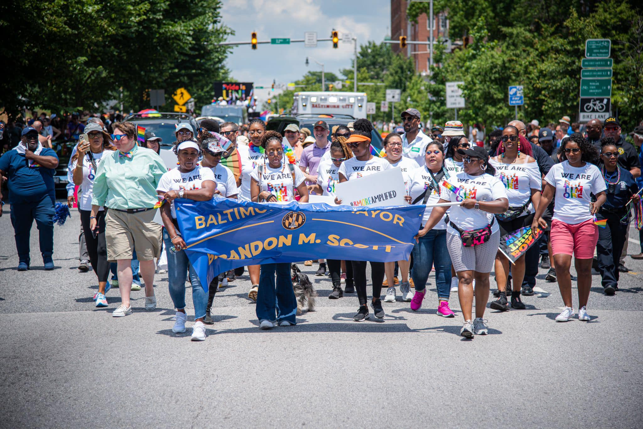 Citizens walking down the street with a Brandon Scott banner